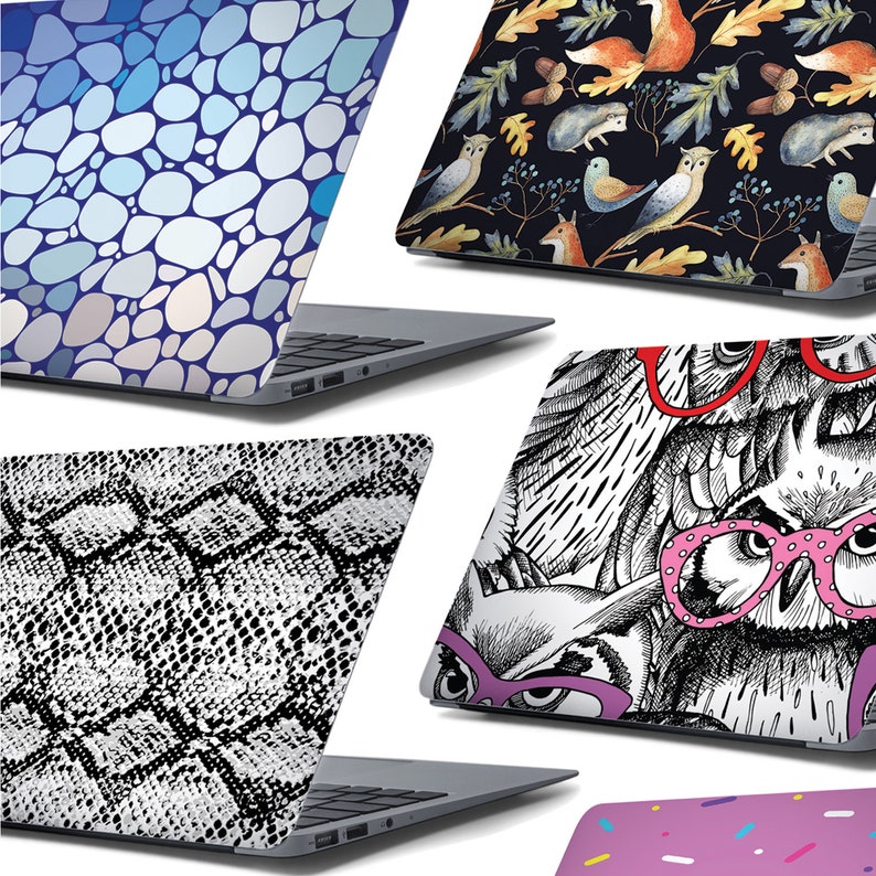 May include: Five different laptop skins with various designs. The skins feature a blue and white pebble pattern, a black and white owl pattern, a black and white snake skin pattern, a black background with watercolour owls, foxes, and leaves, and a pink background with white sprinkles.