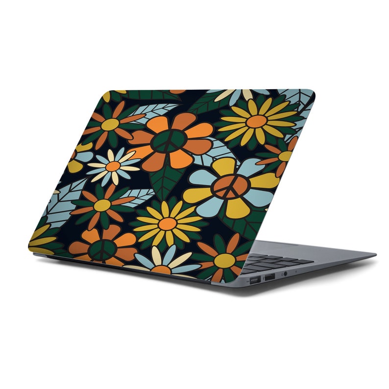 May include: A laptop computer with a floral design on the lid. The design features a variety of flowers in shades of orange, yellow, blue, and green on a dark background.