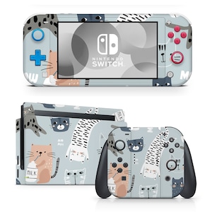 May include: A blue and white Nintendo Switch console and controller skin with a cute cat pattern. The design features cats drinking milk, wearing hats, and playing music. The text "NINTENDO SWITCH" is printed on the console.