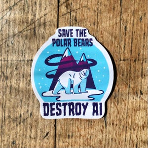 May include: A circular sticker with a polar bear illustration, mountains, and the text "SAVE THE POLAR BEARS DESTROY AI". The design features a white polar bear on a snowy landscape, with purple mountains and a blue sky background.