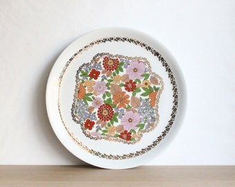 Vintage 70s Pillivuyt round ceramic serving platter or cake plate with a colorful floral and gold tone decor