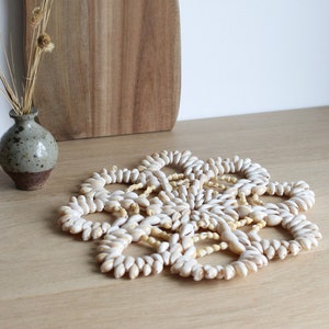 Vintage cowrie seashell doily trivet, floral shaped, 70s boho home decor