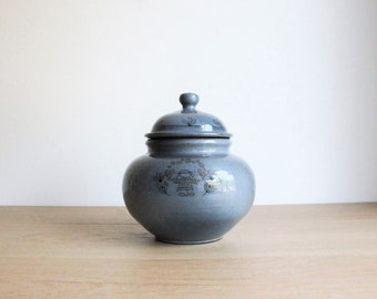 Vintage blue handmade pottery lidded jar with a handpainted naive decor, from a French flea market