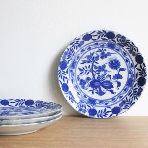 4 vintage mid century Japanese saucers, blue and white porcelain with a blue onion transfer decor