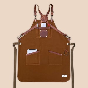 Brown personalized canvas apron with leather patch, utility pockets and side towel loop