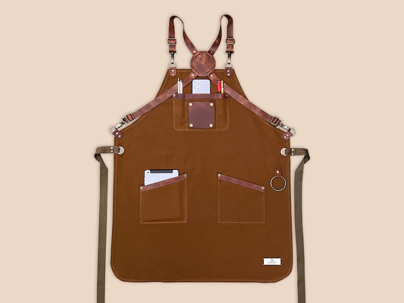 Brown personalized canvas apron with leather patch, utility pockets and side towel loop