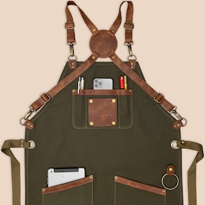 Personalized green work apron with leather pocket details, tool loop and durable canvas body