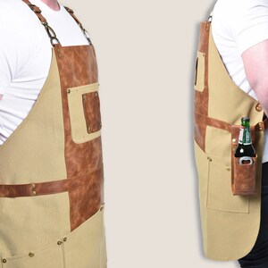 May include: A tan and brown apron with leather accents and multiple pockets. The apron has a built-in bottle opener and a pocket designed to hold a bottle. The apron is designed for use in a kitchen or workshop.