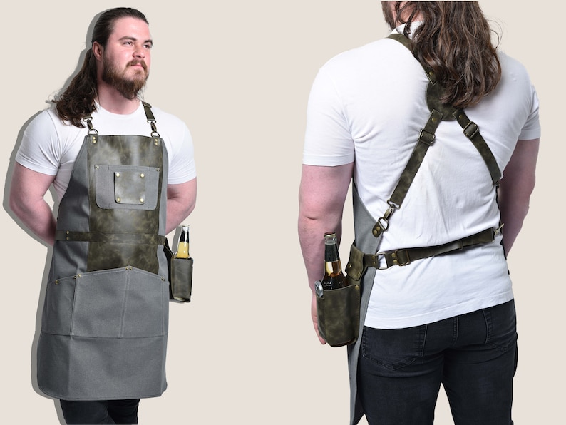 May include: Gray and olive green apron with a leather pocket designed to hold a bottle. The apron has adjustable straps and a pocket on the front. The apron is designed for grilling or bartending.