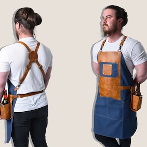 May include: A blue and brown apron with a leather chest pocket and a bottle holder. The apron has adjustable straps and a waist belt. The apron is designed for bartenders or servers.