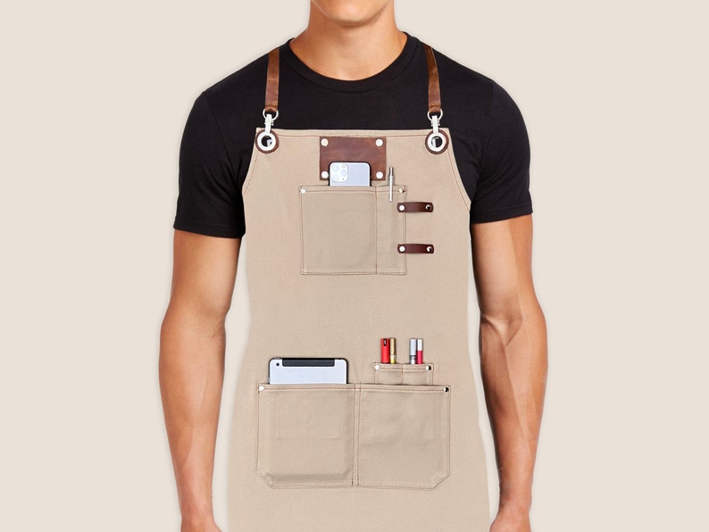 Custom logo apron for men and women with personalized embroidery name tags. Cotton canvas with cross-back leather straps and towel ring. Cotton Seed