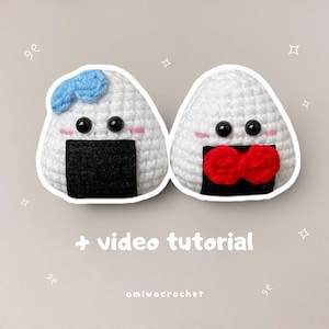 May include: Two crocheted onigiri, a Japanese rice ball, plushies. One is white with a red bow and the other is white with a blue bow.  + video tutorial amiwa crochet