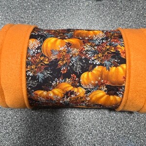 May include: Orange fleece-lined tube with a pumpkin and fall leaf print.