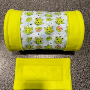 May include: A green and blue fabric tube with a frog pattern. The tube is lined with a bright green fabric. A matching flat piece of fabric is also included.