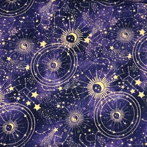 May include: A dark purple fabric featuring a repeating celestial pattern of cream-colored suns, crescent moons, and yin-yang symbols surrounded by radiating lines. The design includes scattered stars, constellations, and comet-like streaks.