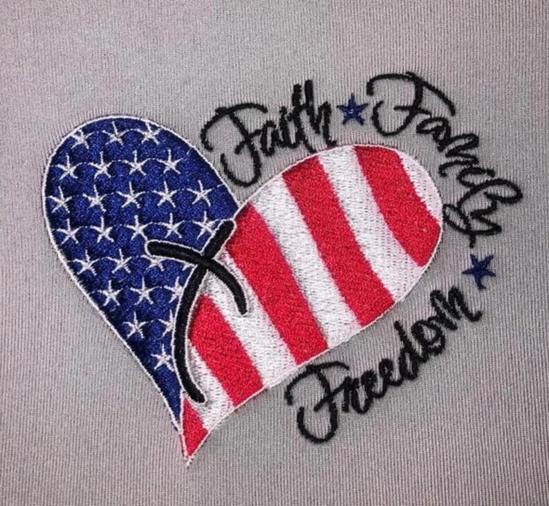 May include: Embroidered design of a heart shaped American flag with the words "Faith Family Freedom" surrounding it.