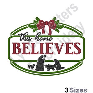 May include: Green and red Christmas sign with a wreath and bow. The sign says "This home believes" and features a nativity scene with Mary, Joseph, and baby Jesus.