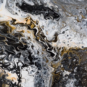 Abstract acrylic pour painting using black, grey, gold, and white paint