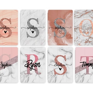 May include: Set of eight personalised tablet cases with marble and rose gold designs. Each case features a different initial and name, including Sophia, Ryan, Tommy, and Oliver.