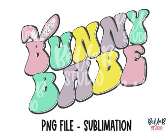 May include: A colorful graphic design with the text "Bunny Babe" in a retro style. The letters are in different pastel colors, including pink, green, yellow, and purple. A pink bunny ear with a white and silver glitter design is on the left side of the design.