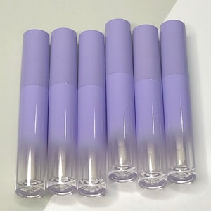 May include: Six clear, empty, lavender-coloured lip gloss tubes with a silver cap.
