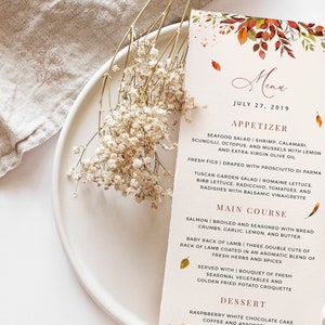 May include: A fall-themed menu with a watercolor illustration of leaves in shades of orange, red, and yellow. The menu lists appetizers, main courses, and desserts. The text reads "Menu" and "July 27, 2019".