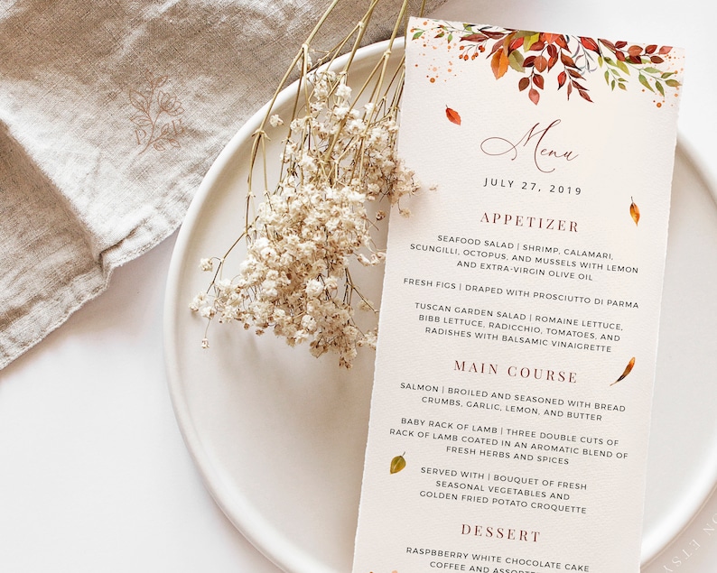 May include: A fall-themed menu with a watercolor illustration of leaves in shades of orange, red, and yellow. The menu lists appetizers, main courses, and desserts. The text reads "Menu" and "July 27, 2019".