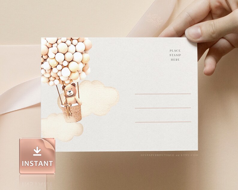 May include: A white postcard with a brown teddy bear in a hot air balloon made of cream and white balloons. The postcard has a place to put a stamp and a space for an address. The text "DIYPAPERSBOUTIQUE on ETSY.COM" is at the bottom of the postcard.