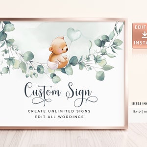 以下が含まれることがあります： 青い風船を持ったかわいい漫画のクマが描かれたデジタル印刷可能なサイン。サインは緑色のユーカリの葉の縁取りがされており、「Custom Sign」という文字と「Create Unlimited Signs Edit All Wordings」というテキストが書かれています。サインには「Sizes Included: 8x10 | 10x8 inch」というテキストも含まれています。