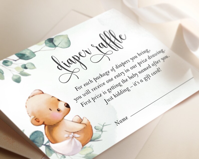 May include: A white card with green foliage and a cute cartoon bear wearing a diaper. The card says "diaper raffle" and includes instructions for a raffle. The text says "For each package of diapers you bring, you will receive one entry in our prize drawing. First prize is getting the baby named after you. Just kidding - it's a gift card!"