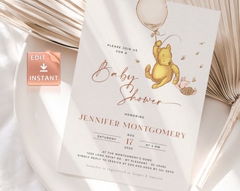 May include: A Winnie the Pooh themed baby shower invitation with a cartoon illustration of Winnie the Pooh and Piglet holding a balloon. The invitation is beige with brown text and a gold border. The text reads "Please join us for a Baby Shower honoring Jennifer Montgomery, Saturday, August 17, 2022 at 4 PM at the Montgomery's Home, 1255 Long Point Rd, Mt Pleasant, SC 29464. Kindly reply to Jessica at 000.000.0000 by July 30th. Jennifer is registered at Target & Amazon."