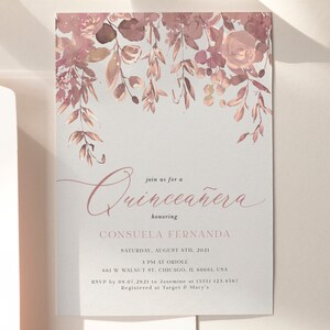 May include: A Quincea&ntilde;era invitation with a watercolor floral design in shades of pink and brown. The text reads "Join us for a Quincea&ntilde;era honoring Consuela Fernanda, Saturday, August 8th, 2021, 3 PM at Oriole, 661 W Walnut St, Chicago, IL 60661, USA, RSVP by 09.07.2021 to Jasmine at (555) 123.4567, Registered at Target & Macy's."