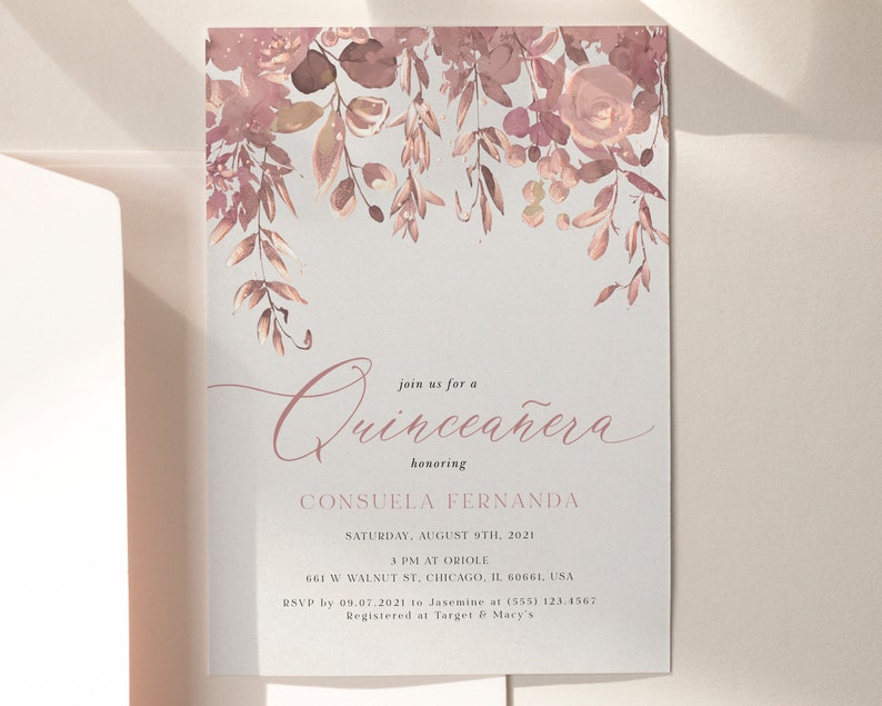 May include: A Quincea&ntilde;era invitation with a watercolor floral design in shades of pink and brown. The text reads "Join us for a Quincea&ntilde;era honoring Consuela Fernanda, Saturday, August 8th, 2021, 3 PM at Oriole, 661 W Walnut St, Chicago, IL 60661, USA, RSVP by 09.07.2021 to Jasmine at (555) 123.4567, Registered at Target & Macy's."