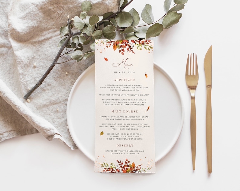 May include: A printable wedding menu card with a watercolor floral design in shades of orange, red, and yellow. The menu features a seafood salad appetizer, salmon main course, and a raspberry white chocolate cake dessert. The text reads "Menu" and "July 27, 2019".