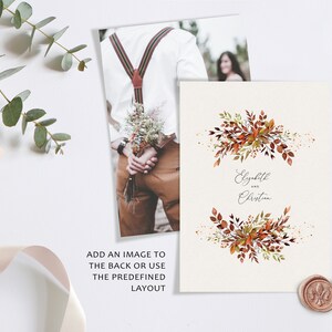 May include: A wedding invitation with a watercolor design of fall leaves in shades of orange, red, and green. The text "Elizabeth and Christian" is written in a cursive font.
