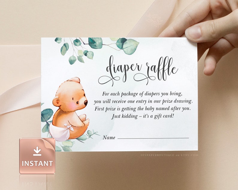 May include: A white card with green leaves and a brown bear illustration. The text "diaper raffle" is written in cursive. The text reads: "For each package of diapers you bring, you will receive one entry in our prize drawing. First prize is getting the baby named after you. Just kidding - it's a gift card!" There is a blank line for a name.