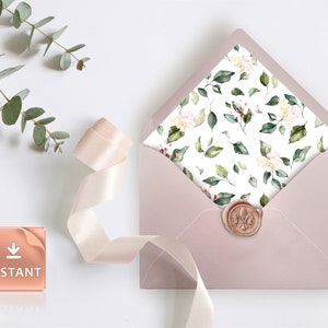 May include: A blush pink envelope with a floral pattern on the inside flap. The envelope is sealed with a wax seal featuring a fleur-de-lis design. A pink ribbon and a eucalyptus sprig are in the background.
