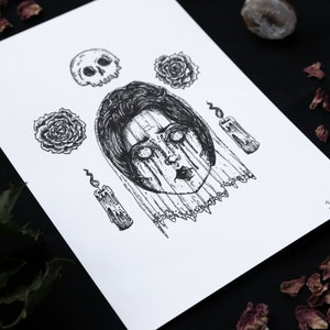 May include: A black and white illustration of a woman's face with a skull, roses, and candles. The woman's face is surrounded by a veil and her eyes are wide open. The image has a dark and gothic aesthetic.