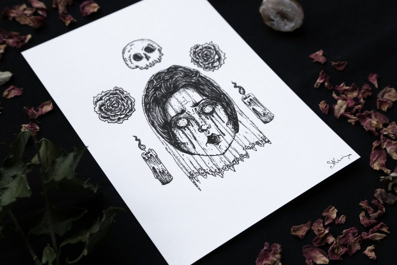 May include: A black and white illustration of a woman's face with a skull, roses, and candles. The woman's face is surrounded by a veil and her eyes are wide open. The image has a dark and gothic aesthetic.