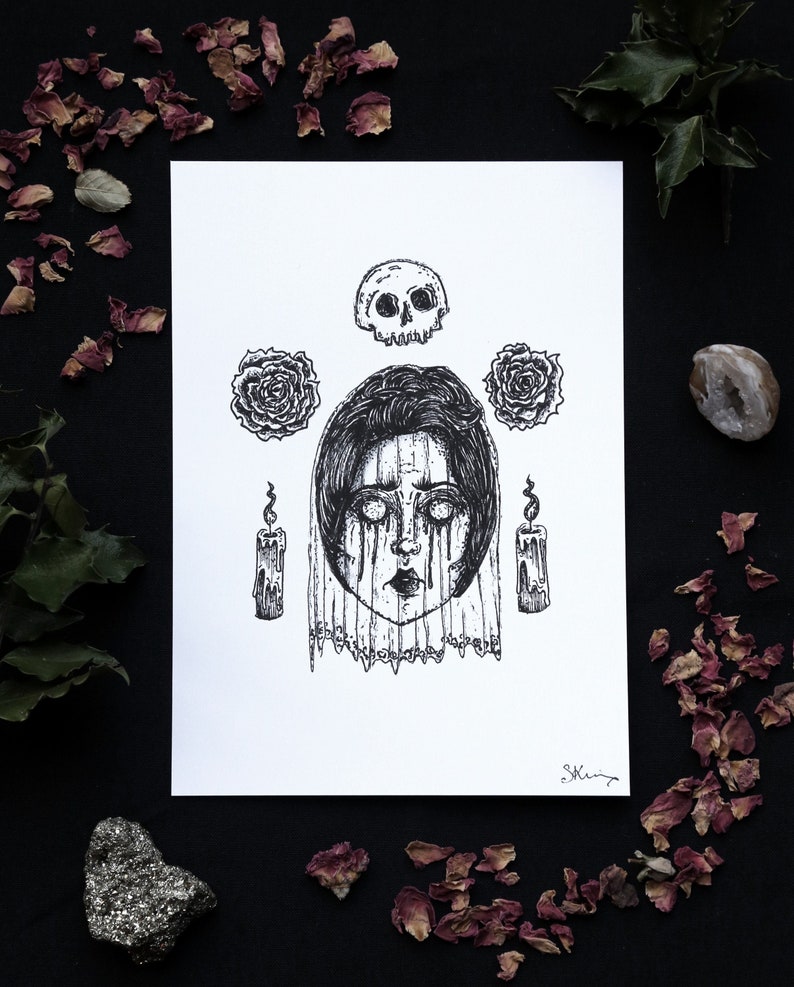 May include: Black and white pen and ink illustration of a woman's face with a skull, roses, and candles. The woman is wearing a veil and has tears running down her face.