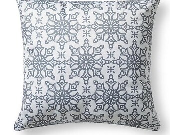 May include: Square throw pillow with a white background and a repeating pattern of gray floral designs. The pillow has a soft, inviting appearance, suitable for home decor.