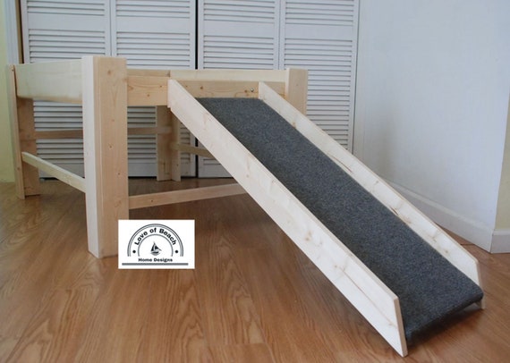 raised dog bed next to bed