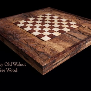 May include: A wooden chessboard crafted from old walnut tree wood. The board features a light brown and dark brown chequered pattern.