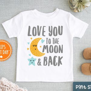 May include: White t-shirt with a gray graphic that says "Love you to the moon & back". The graphic includes a yellow crescent moon with a face and a blue star with a face.