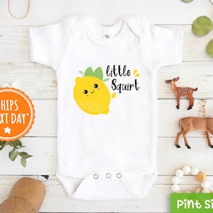 May include: White baby onesie with a yellow lemon graphic and the text "little squirt".