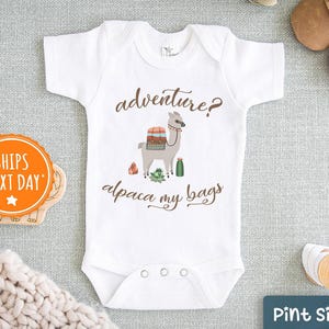 May include: White baby onesie with a llama wearing a saddle and the text "adventure? alpaca my bags".