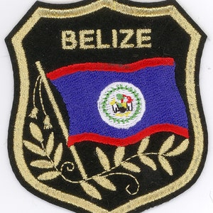 May include: Embroidered patch with a black background and gold trim. The patch features the flag of Belize with the words "BELIZE" above the flag.