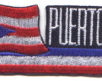 May include: Embroidered patch featuring the flag of Puerto Rico. The flag design includes red and white stripes, a blue triangle with a white star, and the text "PUERTO RICO" in white. A yellow staff and tassels are also present.