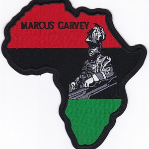 May include: An embroidered patch shaped like the continent of Africa. The patch is red, black, and green, with a black and white image of a man in a military uniform. The text "MARCUS GARVEY" is embroidered in black on the red portion of the patch.