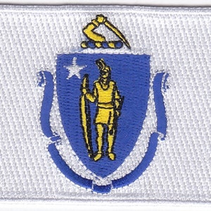 May include: A white patch with the state seal of Massachusetts embroidered in blue, yellow, and black. The seal features a man holding a sword and a star, surrounded by a blue shield and white scrolls.